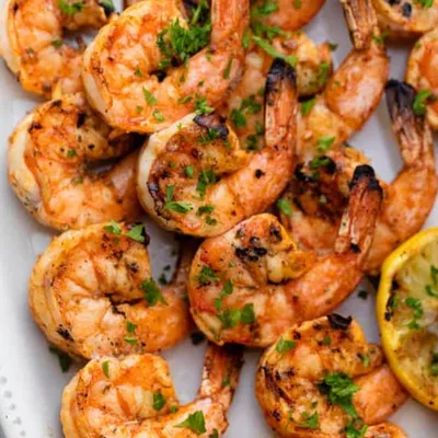 Broiled shrimp skewers with sweet peppers and zhoug
